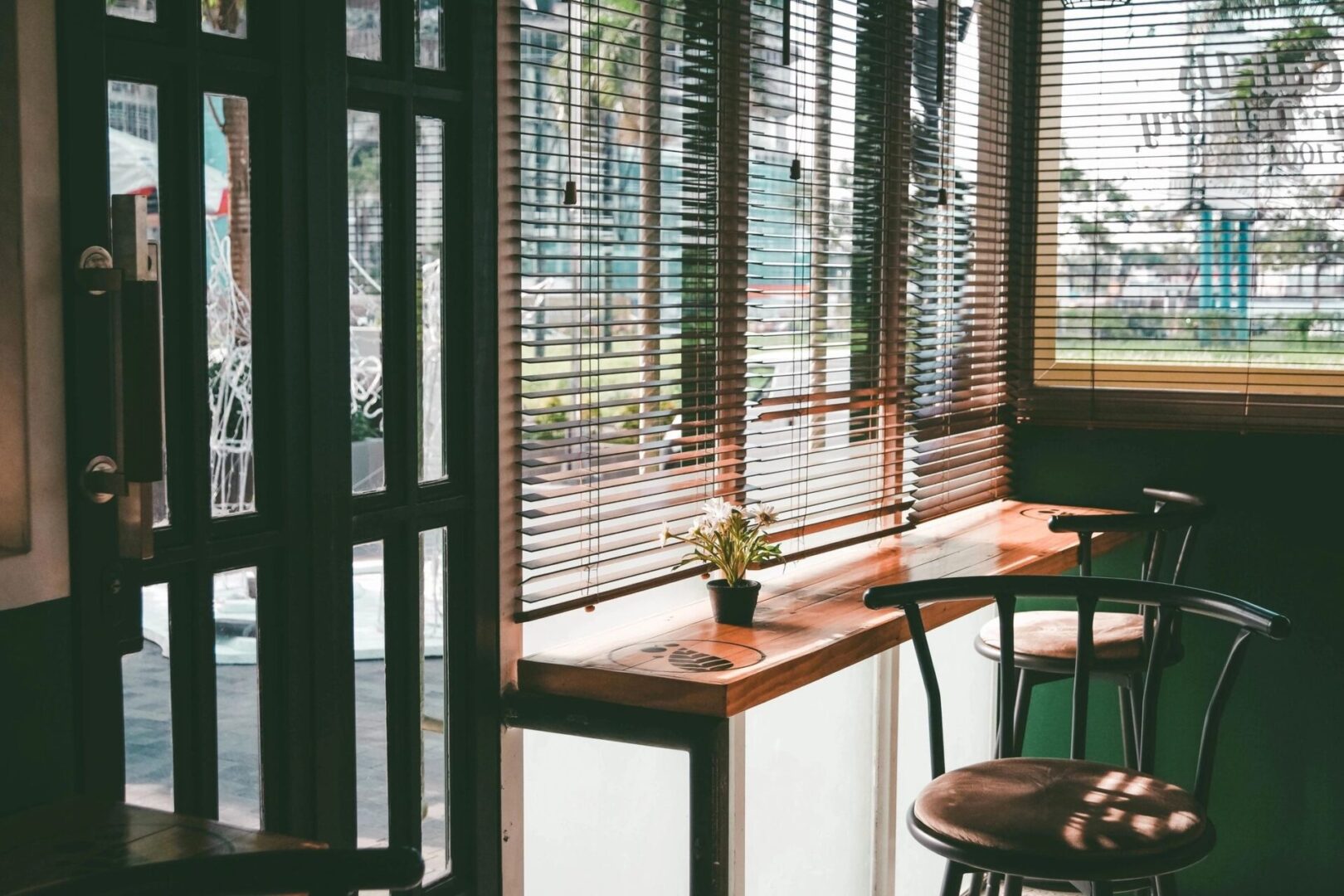 A room with a table and chairs, and a window.