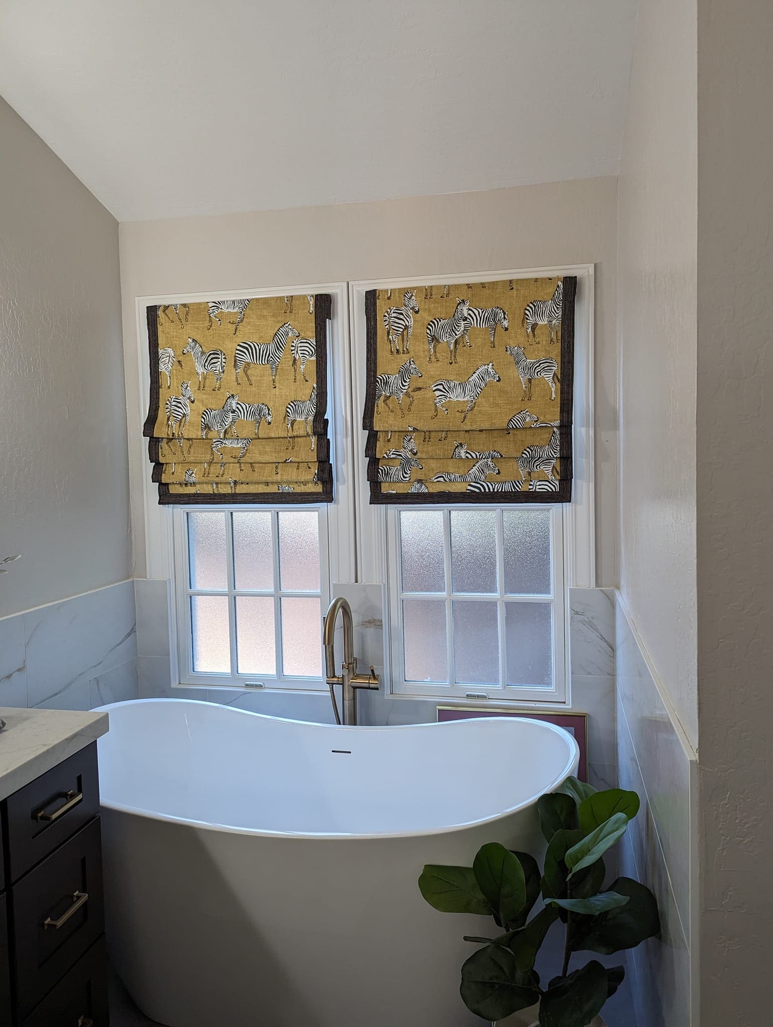 A bathroom with two windows and a tub