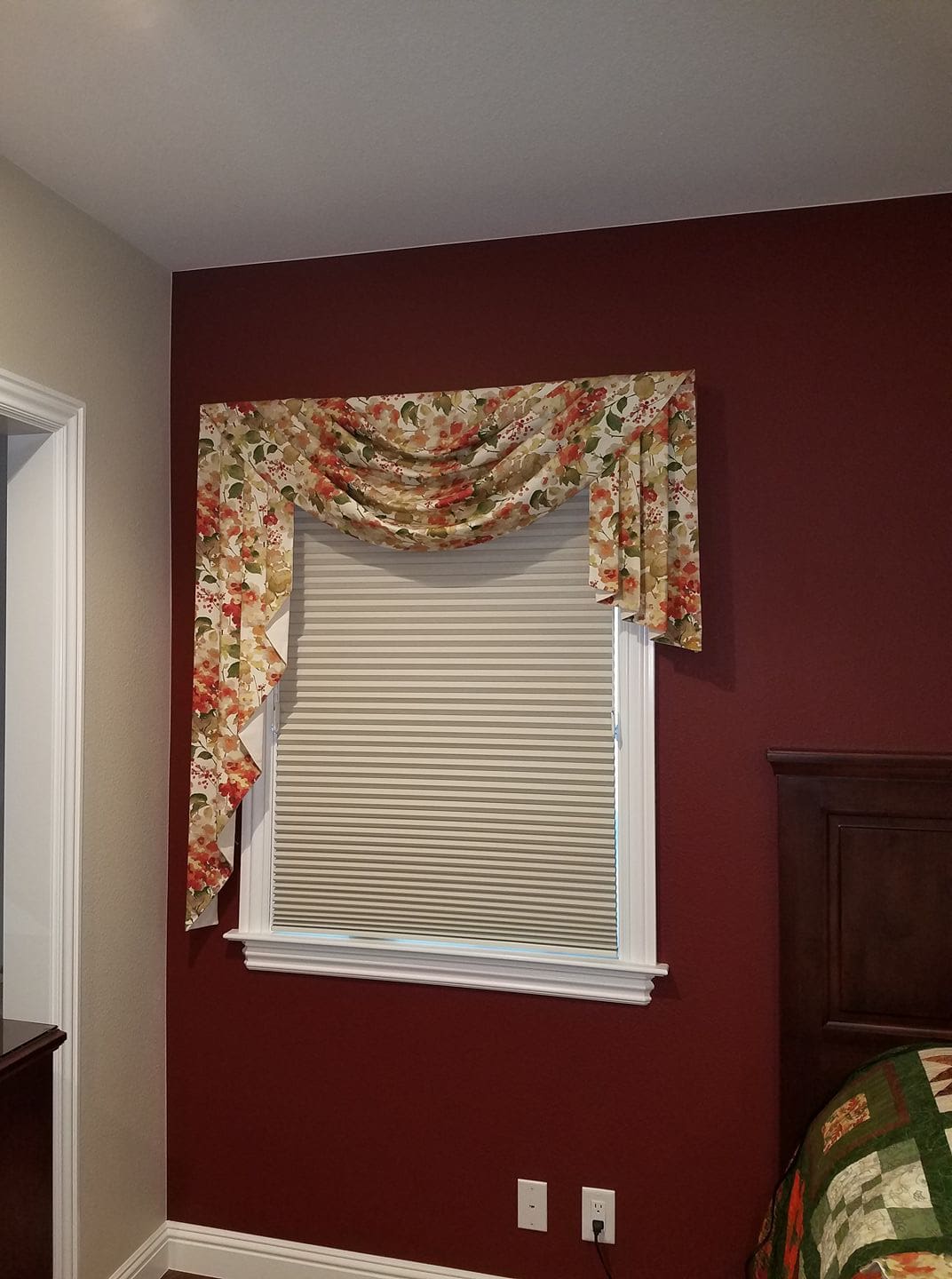 A window with curtains and blinds on the side of it